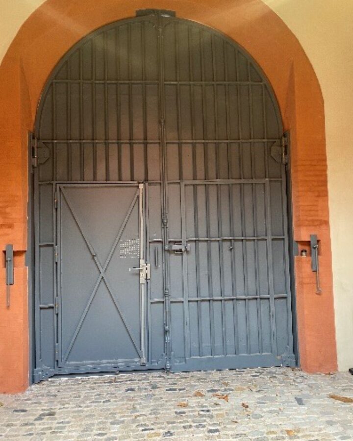 Porte en métal noir dans arche rouge
